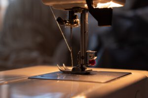 Sewing machine stitching a doll